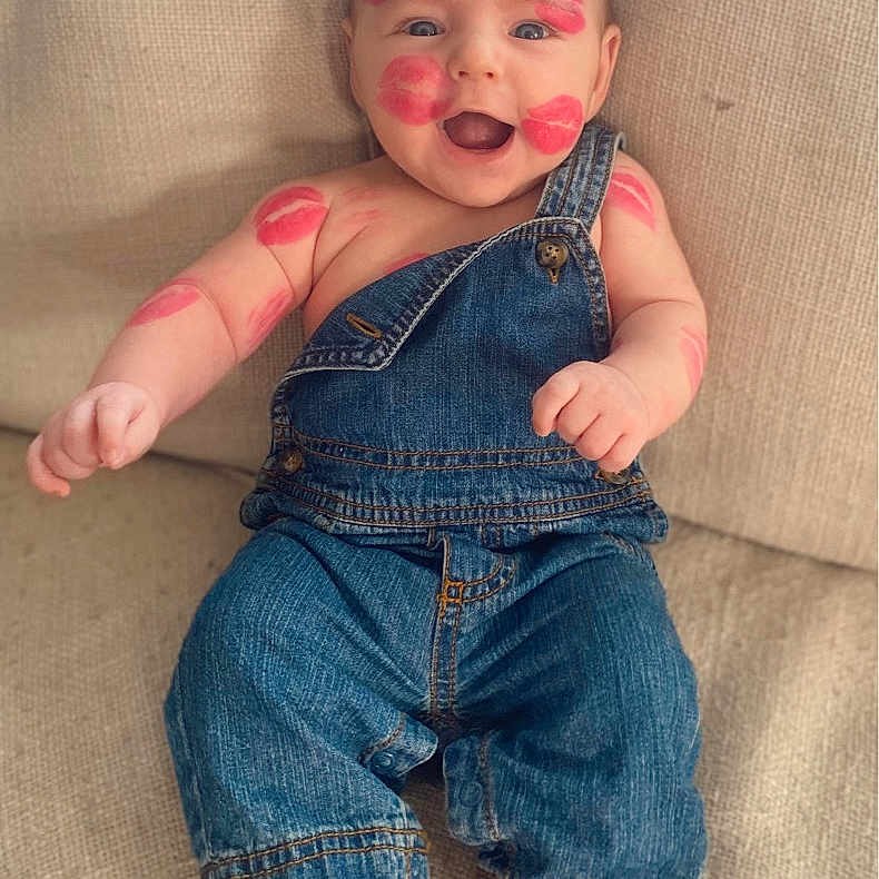 Duke is registered to the contest to win money with this photo: arms, baby, casual, child, clothing, couch, cute, denim_overalls, face, fun, happy, indoors, infant, kiss_marks, love, one_person, portrait, sitting, skin, smiling