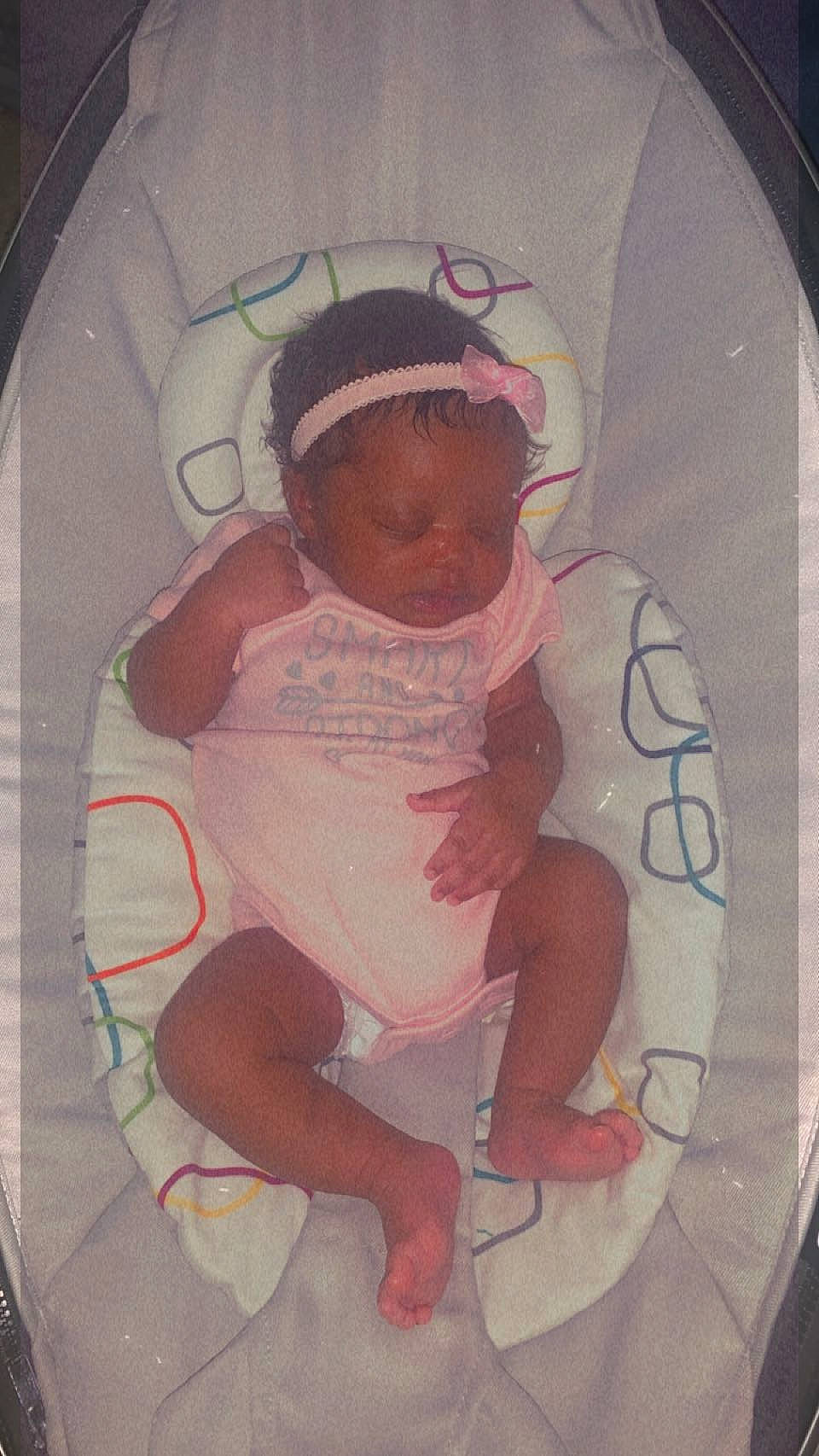 Terri is registered to the contest to win money with this photo: baby, baby_products, baby_toddler_clothing, cheek, child, circle, comfort, fashion_accessory, foot, fun, hairstyle, mouth, person, pink, room, sitting, sleeve, t_shirt, thigh, thumb