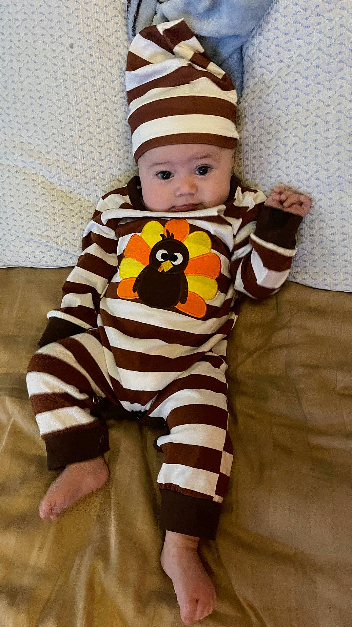 Skylar is registered to the contest to win money with this photo: arm, baby, baby_products, baby_toddler_clothing, cap, clothing, cool, eye, face, facial_expression, flooring, headwear, human_body, orange, outerwear, pattern, person, skin, sleeve, t_shirt
