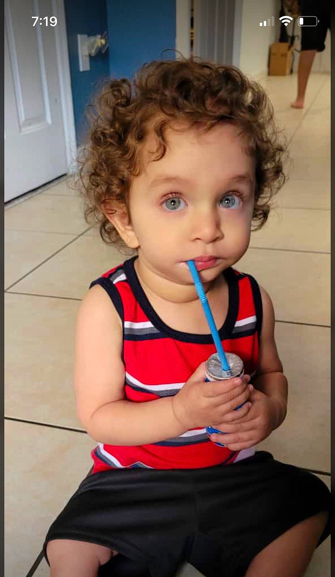 Eli is registered to the contest to win money with this photo: arm, baby_toddler_clothing, beauty, blond, cheek, child, chin, door, flooring, fun, hair, happy, human_body, iris, mouth, nose, person, shoulder, skin, smile