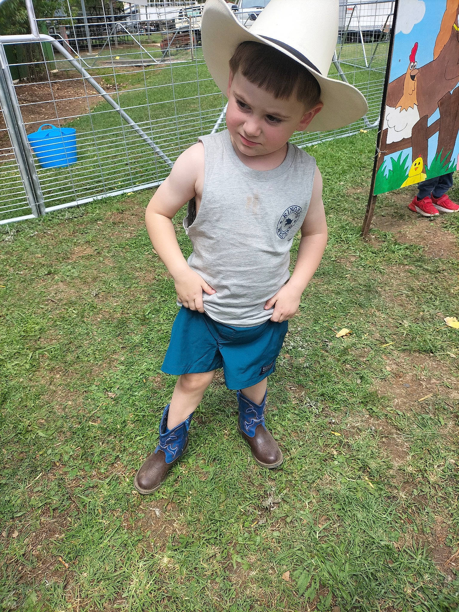 Izaiah is registered to the contest to win money with this photo: child, city, fun, grass, hat, leisure, mesh, outdoor_play_equipment, people_in_nature, person, plant, play, playground, public_space, recreation, sandal, shorts, sitting, soil, sun_hat