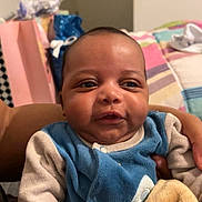 Layann participe au concours pour gagner de l'argent avec cette photo : baby, bedspread, blanket, child, clothing, cozy, cute, expression, face, furniture, hand, head, holding, indoor, infant, person, portrait, skin, smiling, young