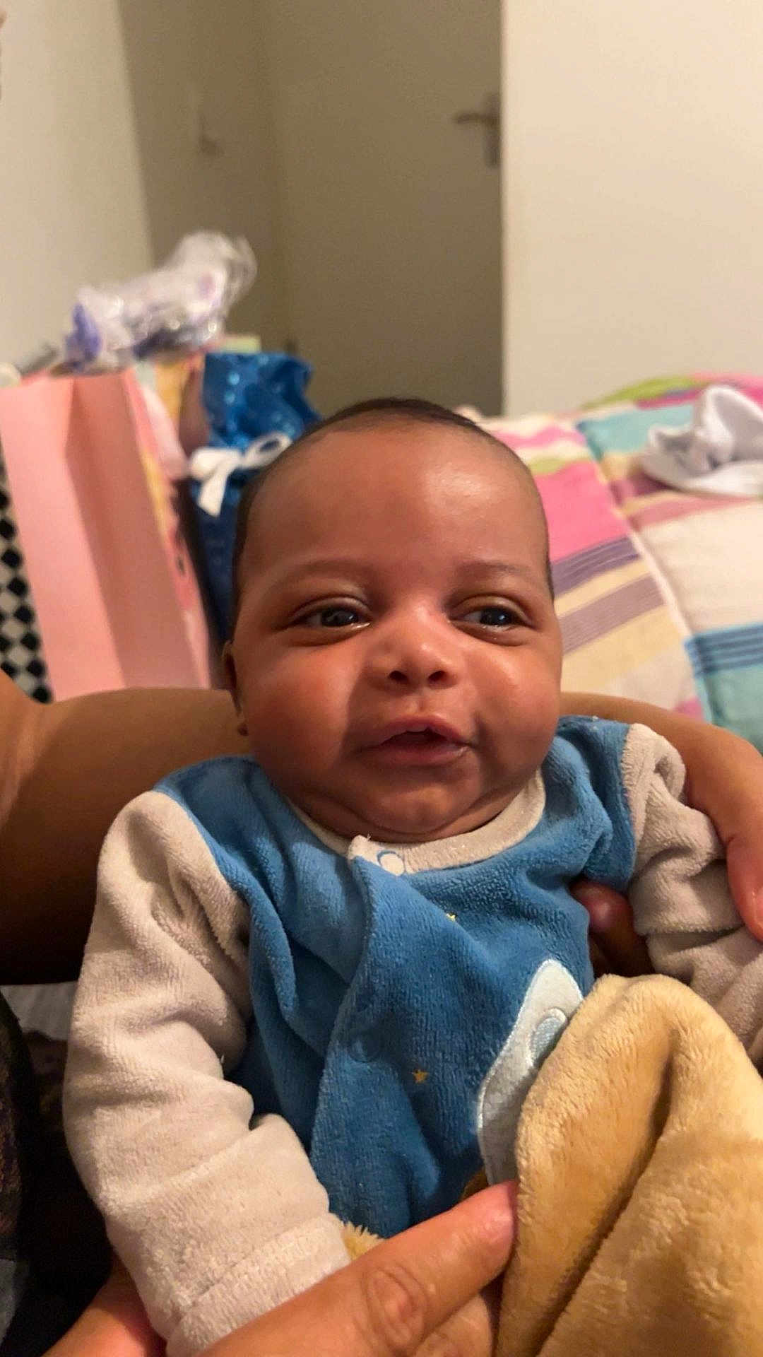 Layann participe au concours pour gagner de l'argent avec cette photo : baby, bedspread, blanket, child, clothing, cozy, cute, expression, face, furniture, hand, head, holding, indoor, infant, person, portrait, skin, smiling, young