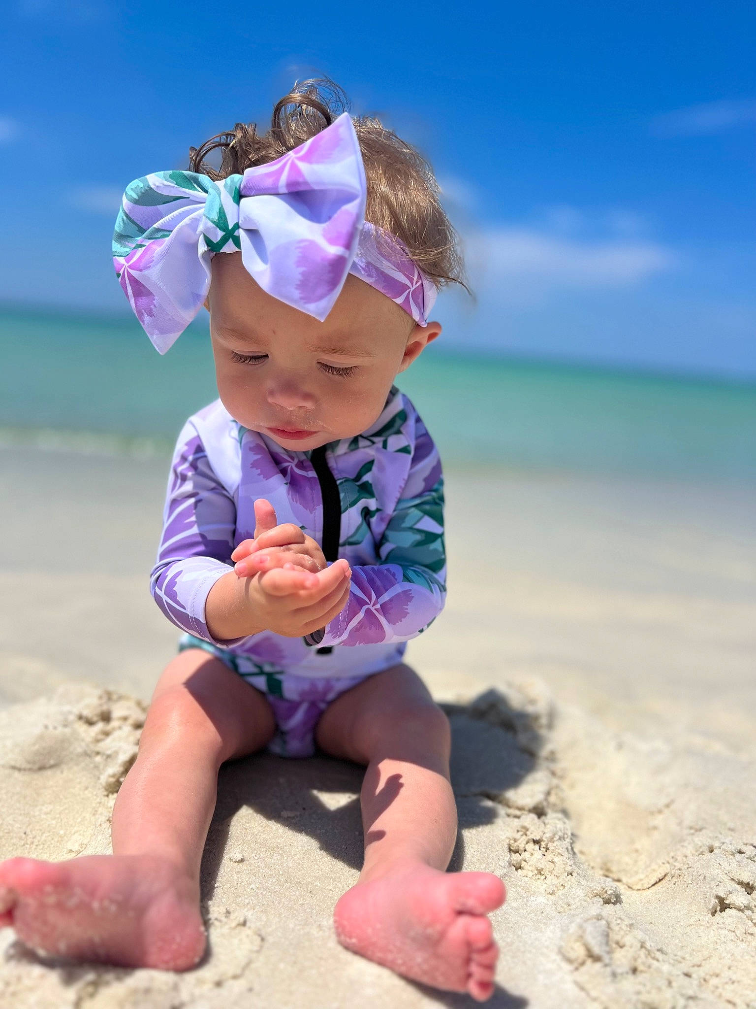 Della joined the competition — help win amazing prizes! azure, baby, baby_toddler_clothing, beach, child, cloud, electric_blue, face, fashion_accessory, foot, fun, goggles, happy, hat, headwear, people_in_nature, people_on_beach, person, sand, sky