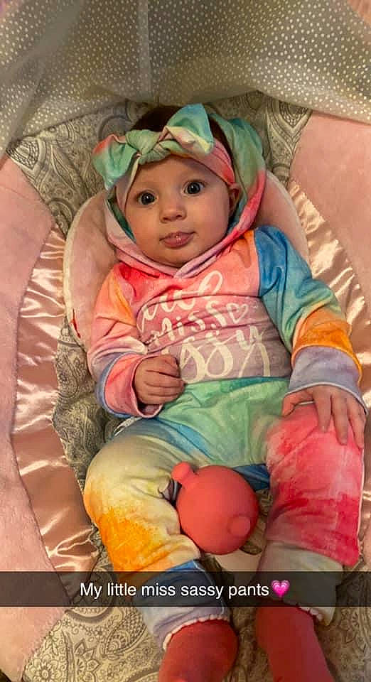 Hazelee is registered to the contest to win money with this photo: baby, baby_products, baby_toddler_clothing, bonnet, cheek, child, comfort, headwear, lap, linens, peach, person, pink, sitting, skin, toddler