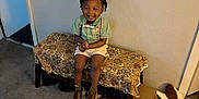 Kydorris joined the competition — help win amazing prizes! toddler, child, smiling, sitting, bench, carpet, indoor, clothing, shoes, box, wall, door, bow_tie, suspenders, happy, person, patterned_fabric, brown_shoes, shorts, hairstyle