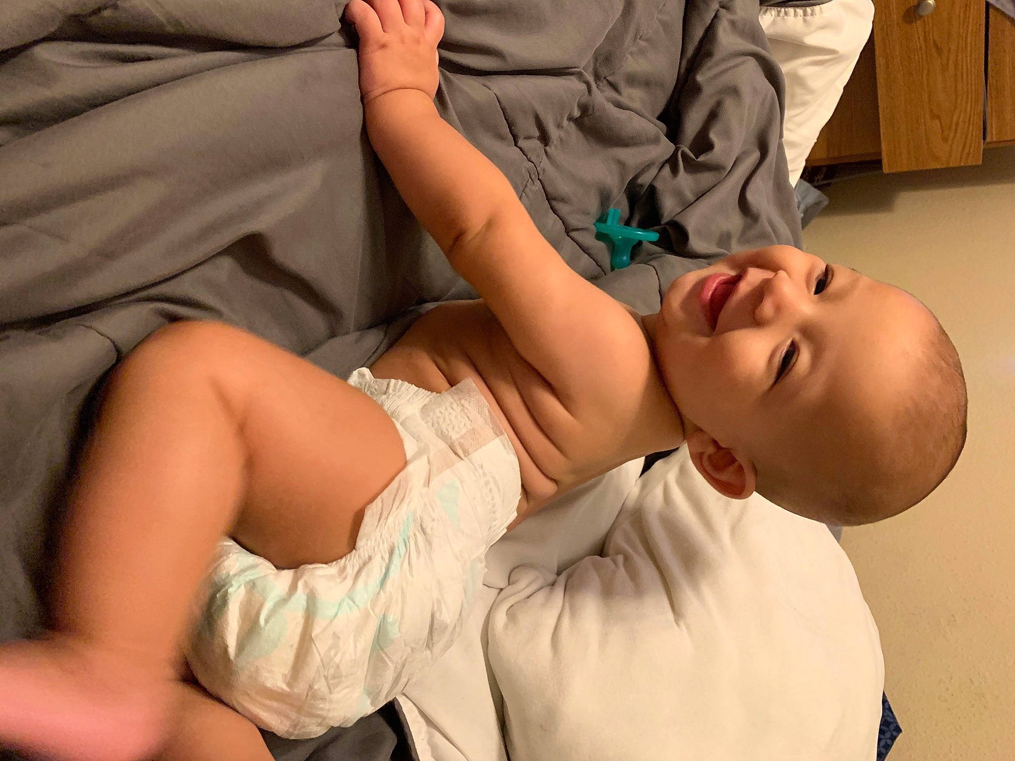 Elijah is registered to the contest to win money with this photo: arm, baby, child, ear, finger, gesture, hand, joint, leg, mouth, muscle, neck, person, shoulder