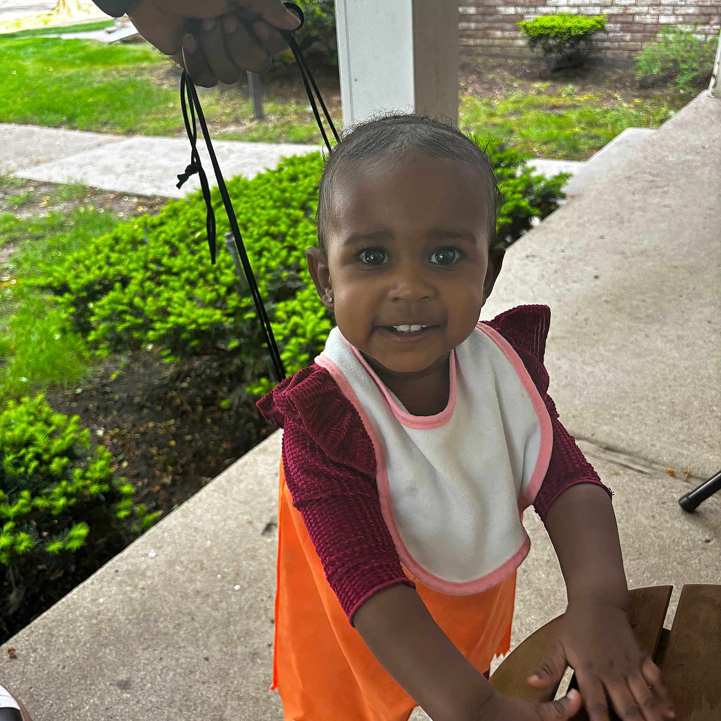 Kenzie is registered to the contest to win money with this photo: adult, bodypart, child, clothing, face, female, finger, footwear, girl, hand, happy, head, male, outdoors, person, photography, portrait, shoe, sitting, smile