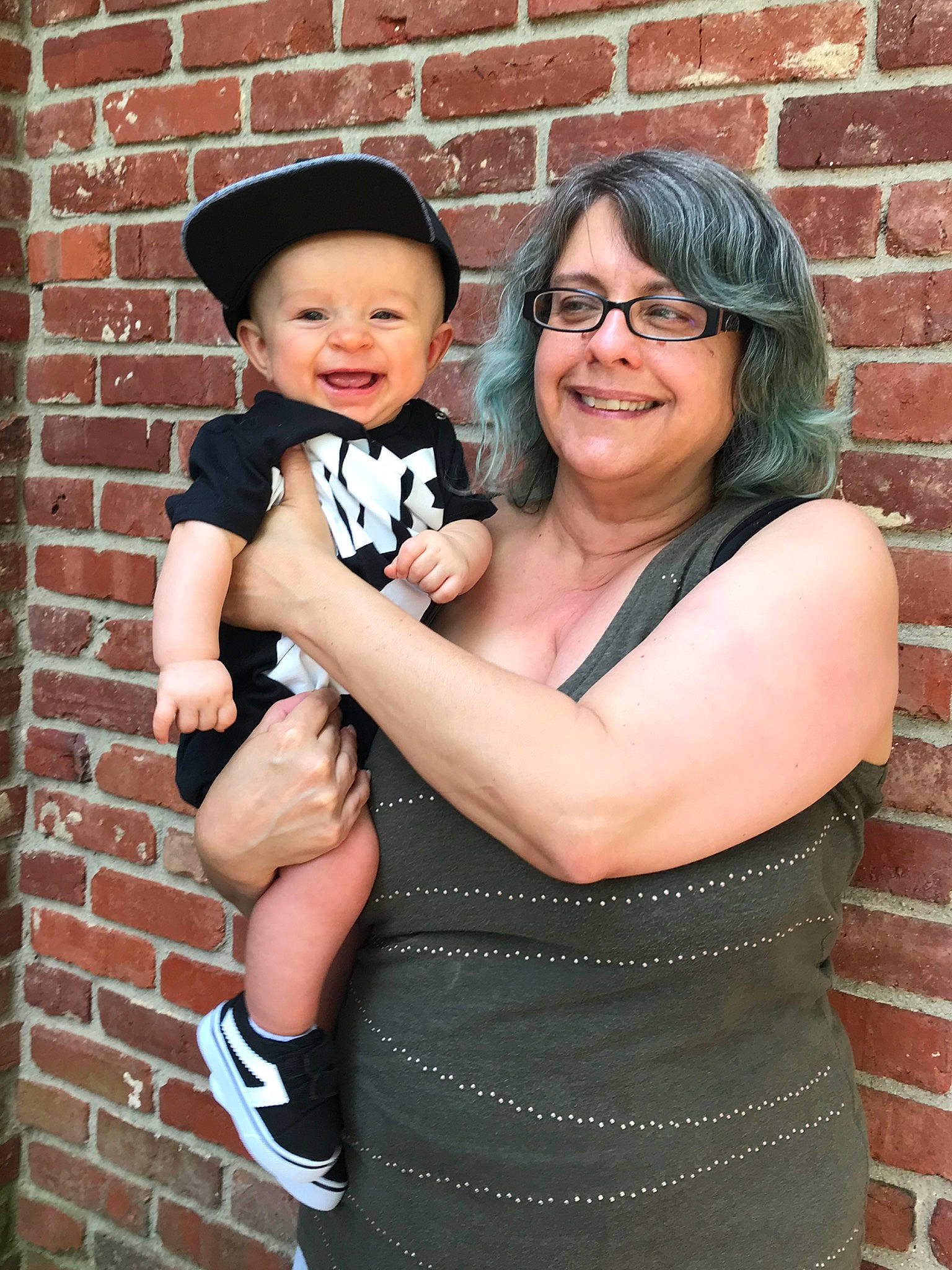 Tate is registered to the contest to win money with this photo: child, family, fashion_accessory, formal_wear, glasses, hat, headgear, headwear, joy, people, person, photography, smile, toddler
