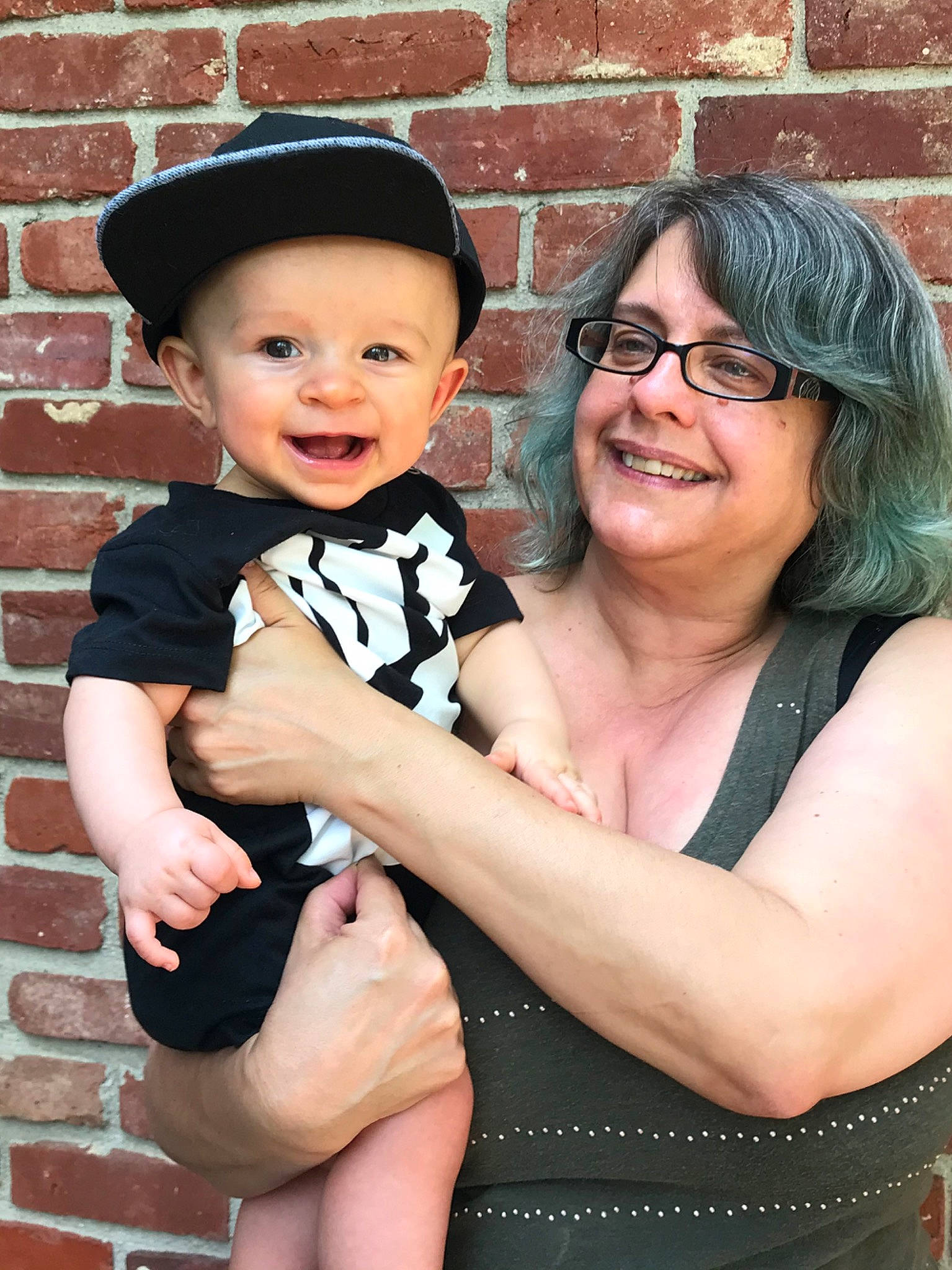 Tate is registered to the contest to win money with this photo: abdomen, baby, child, family, formal_wear, glasses, headgear, headwear, joy, person, toddler