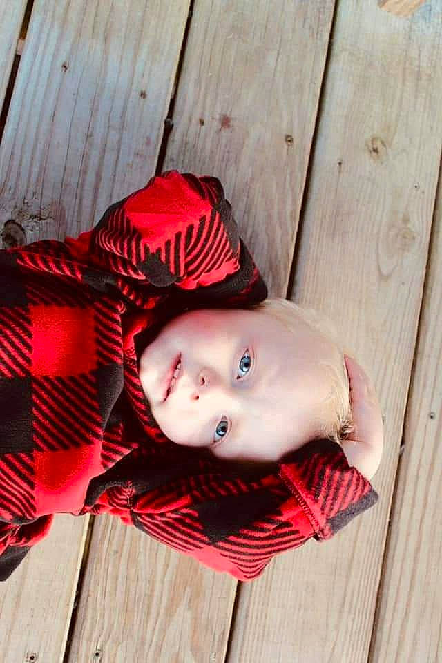 Knox is registered to the contest to win money with this photo: baby, baby_toddler_clothing, carmine, child, costume, doll, fashion_accessory, flooring, fur, hardwood, lip, magenta, outerwear, pattern, person, personal_protective_equipment, sitting, toddler, toy, wood