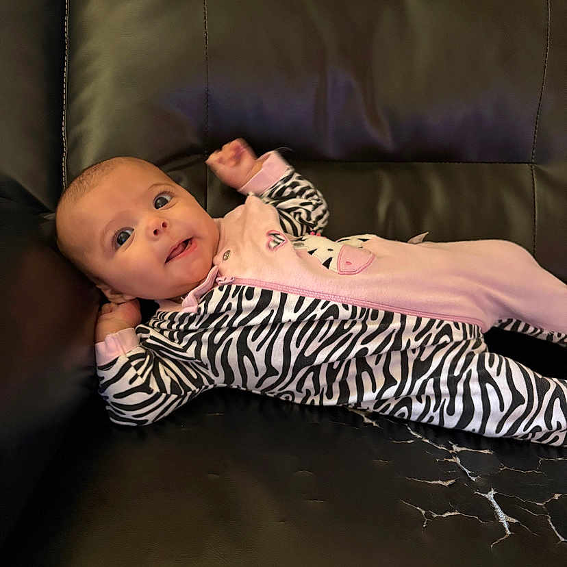 Zieyanna is registered to the contest to win money with this photo: baby, blanket, bodypart, chair, clothing, couch, cushion, dress, face, finger, furniture, hand, happy, head, homedecor, newborn, person, photography, portrait, smile