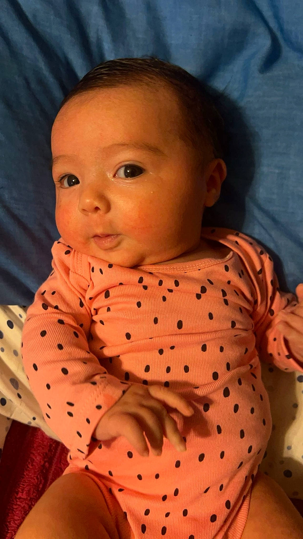 Jhene is registered to the contest to win money with this photo: arm, baby, baby_toddler_clothing, cheek, child, chin, collar, face, facial_expression, head, lip, neck, nose, orange, pattern, person, pink, skin, sleeve, standing