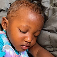 Judea is registered to the contest to win money with this photo: child, toddler, sleeping, face, hair, braids, earring, blanket, bed, pajamas, pastel_colors, peaceful, closeup, skin, eyelashes, arm, comfort, rest, indoors, cute