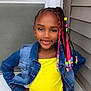 child, girl, smile, braided_hair, beads, yellow_dress, denim_jacket, pose, door, house, window, porch, hand_on_hip, outdoor, fashion, expression, person, portrait, young, confident