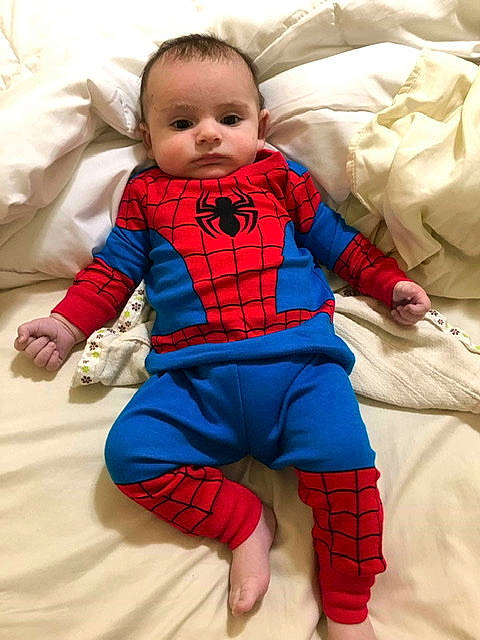 Josh is registered to the contest to win money with this photo: baby, blue, child, costume, design, electric_blue, fictional_character, outerwear, pajamas, pattern, person, plaid, red, skin, sleeve, smile, spider_man, superhero, superman, textile
