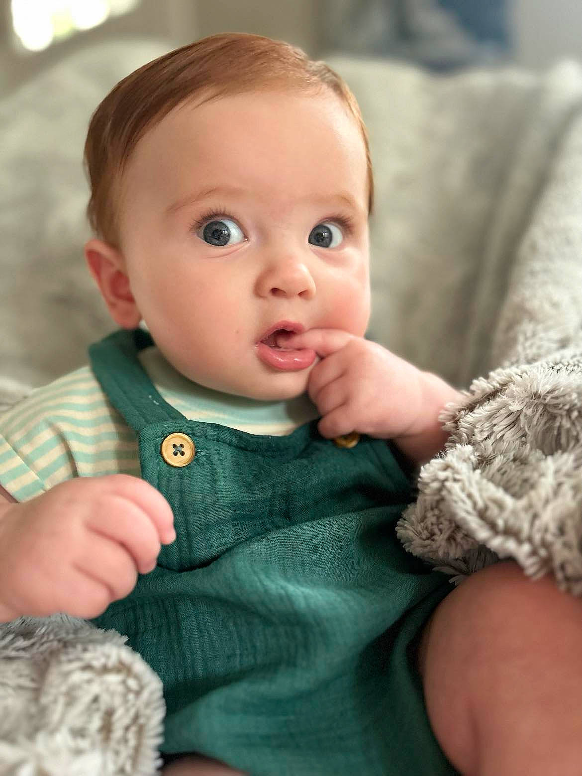 Everett is registered to the contest to win money with this photo: baby, baby_toddler_clothing, cheek, child, chin, comfort, eye, face, finger, gesture, iris, lip, mammal, nose, person, skin, sleeve, surprise, textile, toddler