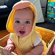 Cody joined the competition — help win amazing prizes! baby, child, costume, yellow, duck, basket, indoor, smiling, happy, cute, clothing, face, person, infant, seat, furniture, expression, pampers, home, floor