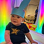 Cody joined the competition — help win amazing prizes! baby, child, bunny_ears, headband, blue, rainbow_lights, reflection, mirror, smiling, star, shirt, indoor, person, cute, happy, colorful, playful, infant, portrait, seated