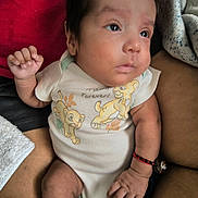 Nikolas joined the competition — help win amazing prizes! baby, blanket, bracelet, cartoon, child, closeup, clothing, comfort, cute, expression, face, hand, indoor, infant, lap, lion_king, onesie, person, resting, skin