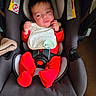 Hector joined the competition — help win amazing prizes! baby, bib, car_seat, child, childcare, comfort, cute, face, head, indoor, infant, pacifier, person, red_clothing, resting, seatbelt, sitting, sleepwear, soft_fabric, young