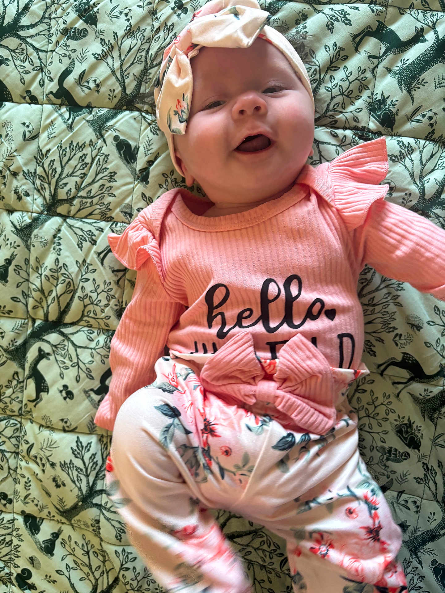 Abigail joined the competition — help win amazing prizes! baby, infant, smiling, headband, pink_clothing, floral_pattern, blanket, cute, happy, lying_down, child, portrait, indoors, soft_lighting, face, ribbon, toddler, playful, fashion, closeup