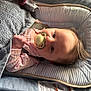 baby, pacifier, blanket, infant, cushion, baby_seat, soft_texture, clothing, pink, striped, face, hand, light, shadow, hair, indoors, comfort, relaxation, child, person