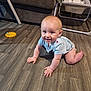 Jace is registered to the contest to win money with this photo: baby, crawling, floor, wooden_floor, smiling, indoor, child, toy, couch, blanket, baby_clothes, furniture, happy, person, home, living_room, flooring, infant, head, cute