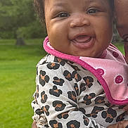 Kalani joined the competition — help win amazing prizes! baby, babylaughing, cap, clothing, coat, face, grass, happy, hat, head, jacket, knitwear, laughing, lawn, person, photography, plant, portrait, sitting, smile