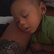 Elias is registered to the contest to win money with this photo: baby, child, sleeping, resting, green_shirt, person, leg, intimate, cozy, indoor, portrait, peaceful, closeup, face, young_child, casual_clothing, relaxation, head, human, comfort