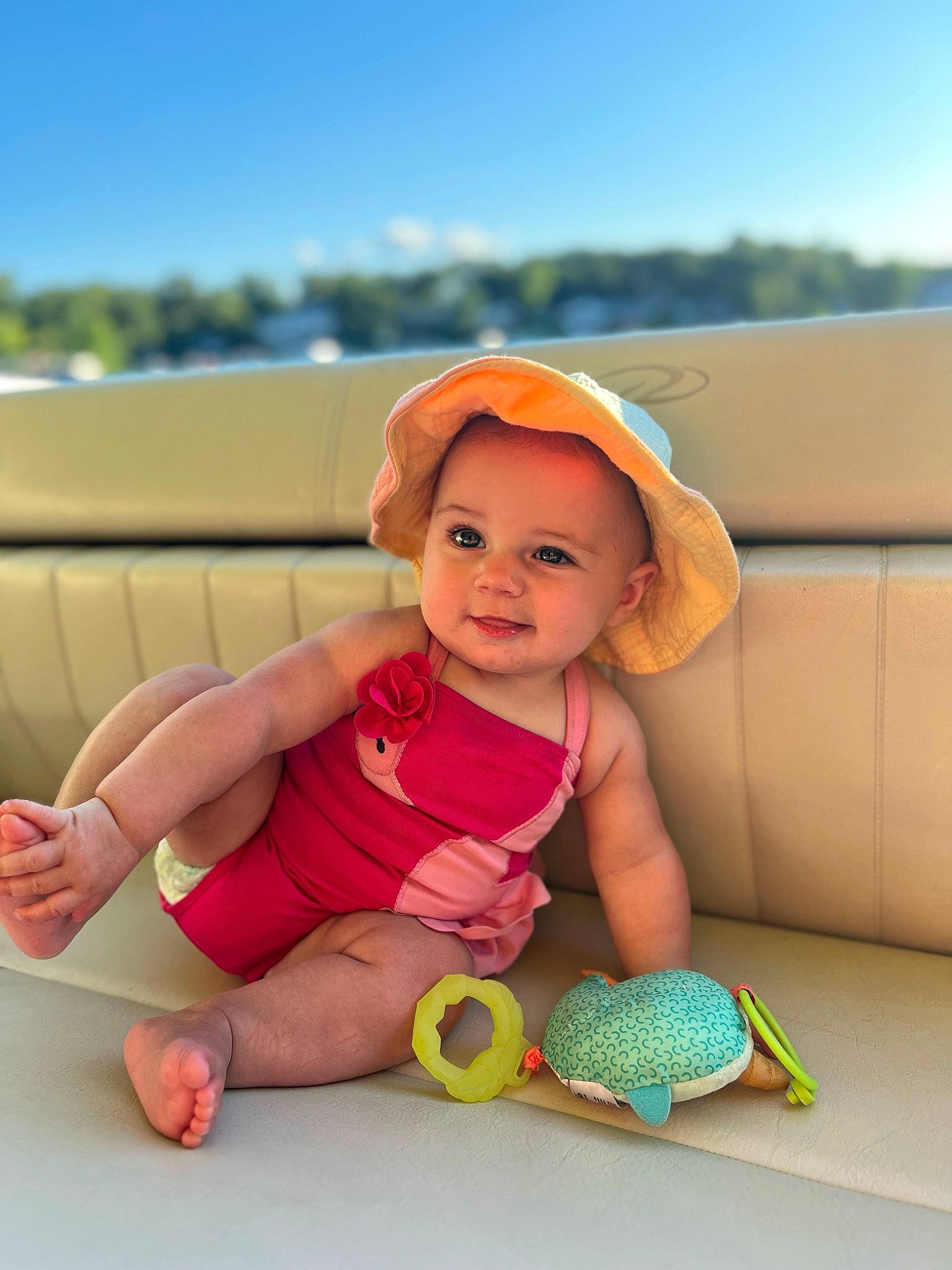 Demi is registered to the contest to win money with this photo: baby, baby_playing_with_toys, baby_toddler_clothing, child, comfort, flooring, fun, happy, hat, human_leg, joy, knee, leisure, person, play, sitting, skin, sky, thigh, toddler