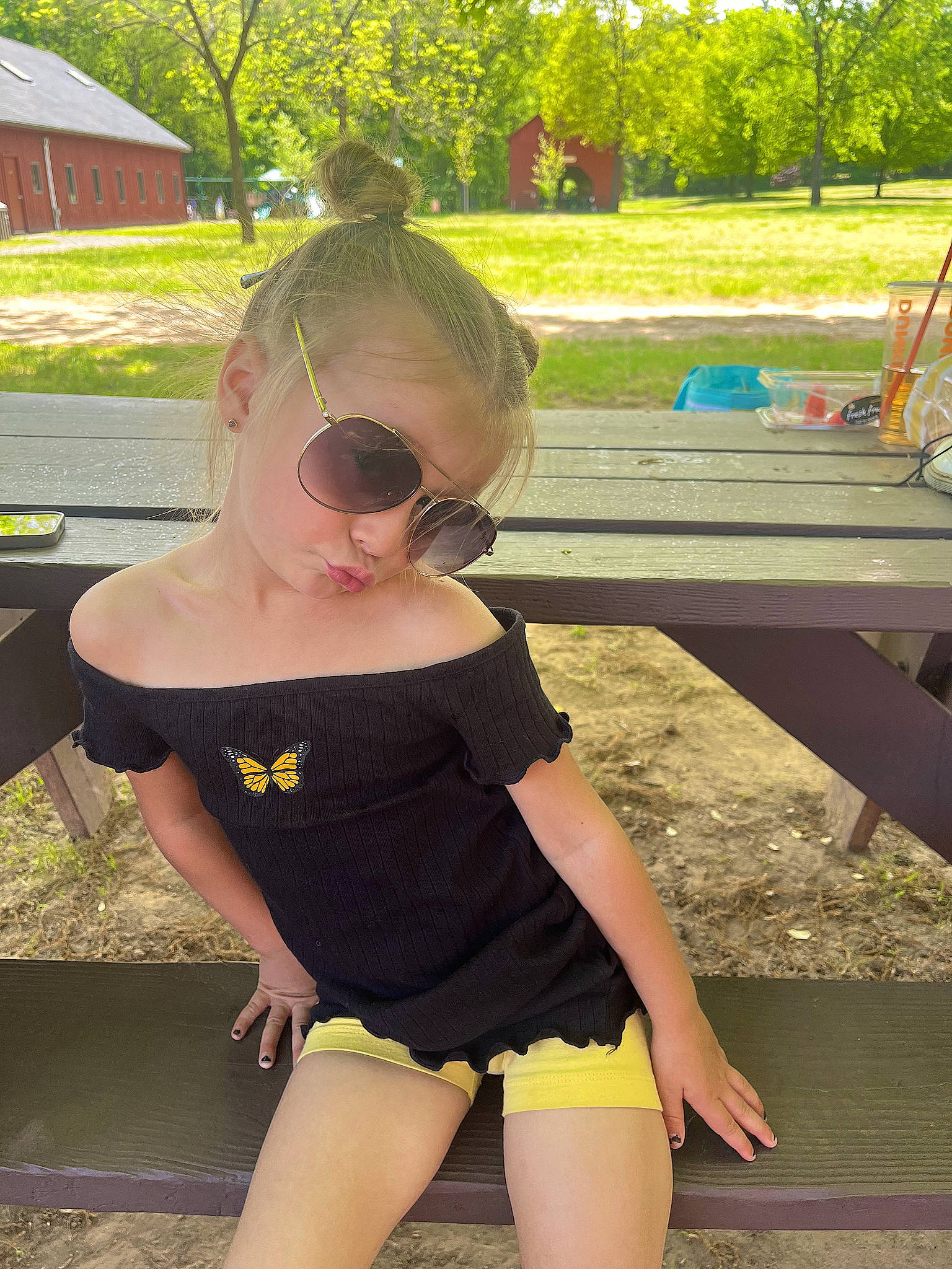 Aria is registered to the contest to win money with this photo: cool, eyewear, fun, glasses, goggles, grass, happy, leaf, leisure, person, pink, plant, public_space, recreation, sleeve, sunglasses, sunlight, thigh, vision_care, waist