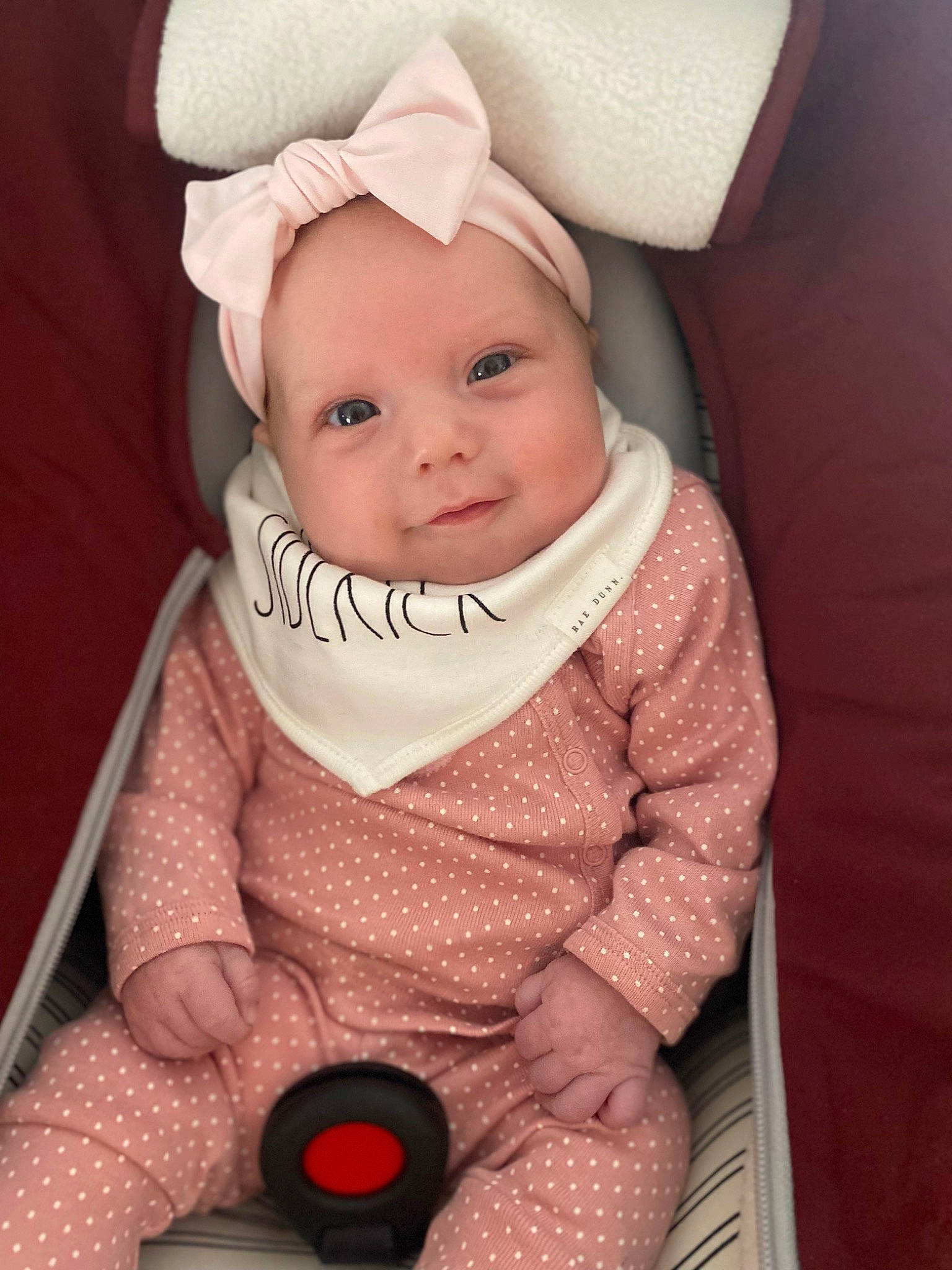 Brynlee is registered to the contest to win money with this photo: baby, baby_carriage, baby_products, baby_toddler_clothing, cap, cheek, comfort, headwear, human_body, iris, knit_cap, lip, outerwear, person, pink, product, sitting, skin, sleeve, toddler