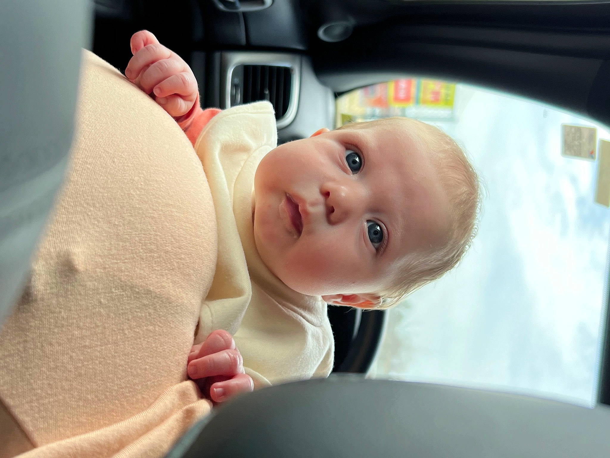 Brynlee joined the competition — help win amazing prizes! auto_part, automotive_design, automotive_mirror, baby, car, car_seat, comfort, finger, gesture, hand, head_restraint, nose, person, personal_luxury_car, rear_view_mirror, seat_belt, skin, smile, steering_wheel, toddler