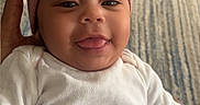 Janelle joined the competition — help win amazing prizes! baby, carpet, child, cozy, cute, face, hand, happy, headwear, indoor, infant, person, pink_bow, portrait, sitting, skin, smiling, toddler, tongue_out, white_clothing
