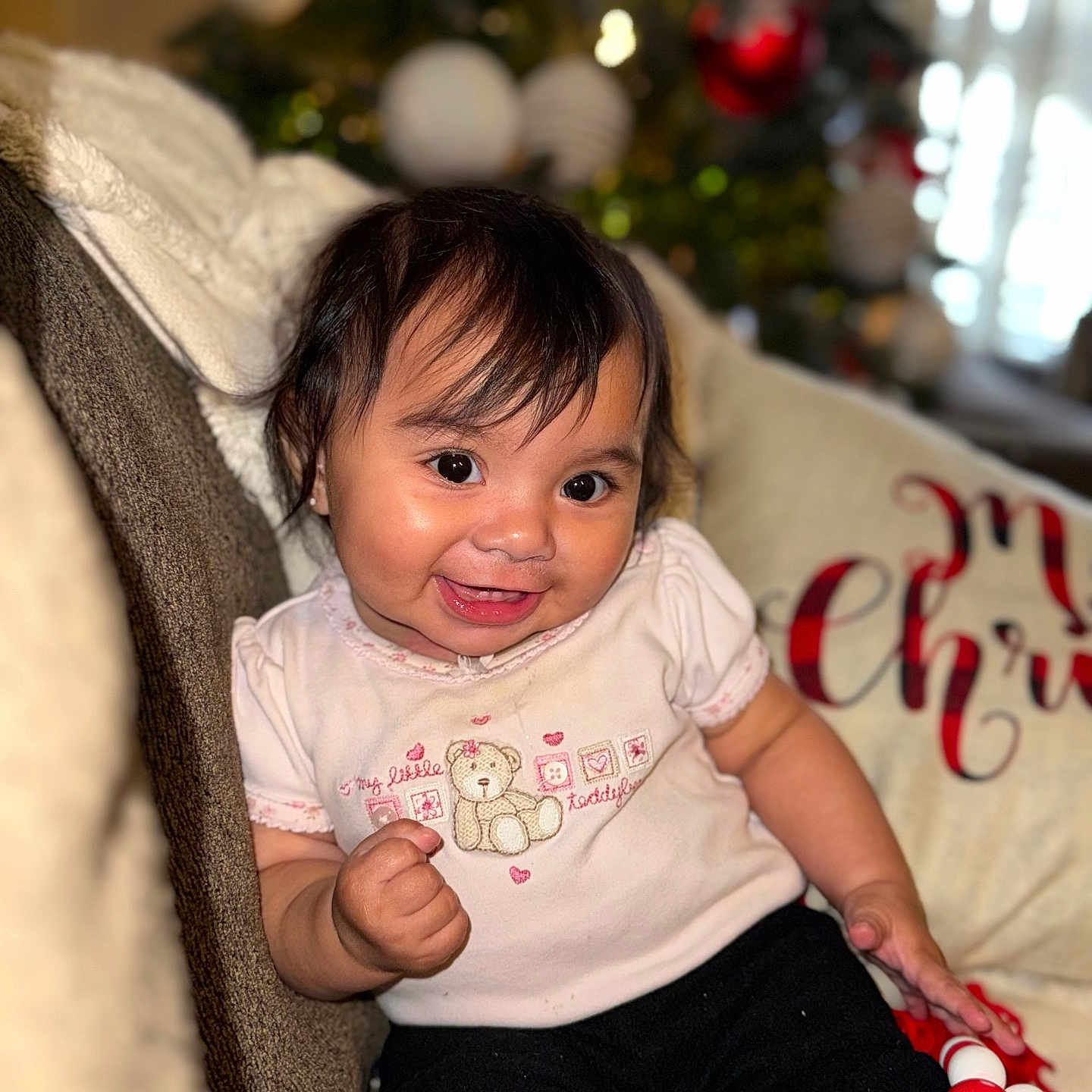 Eliana joined the competition — help win amazing prizes! accessories, baby, bodypart, clothing, couch, cushion, face, finger, furniture, hand, happy, head, homedecor, pants, person, photography, portrait, sitting, smile, t_shirt