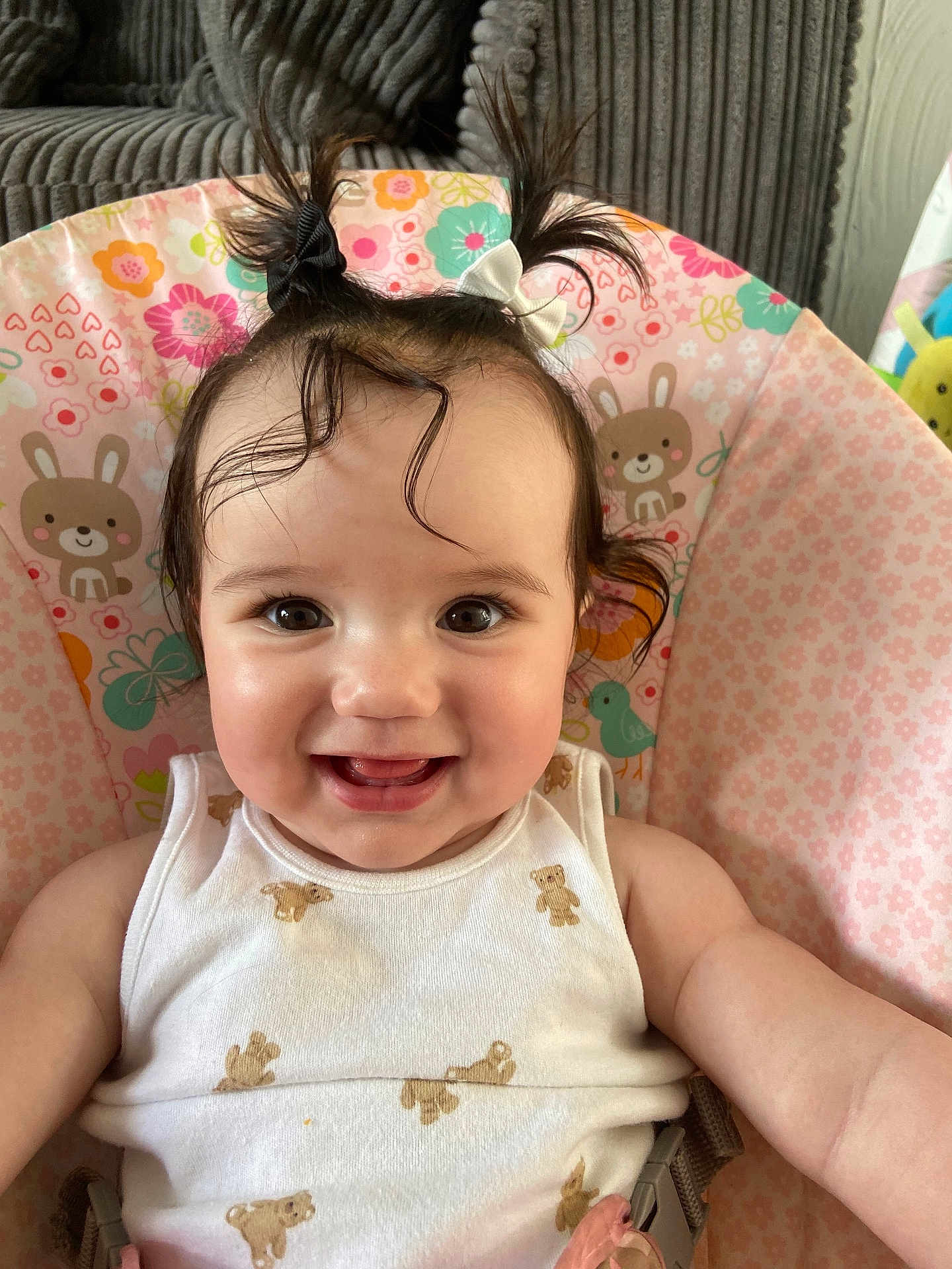 Alora joined the competition — help win amazing prizes! baby, baby_seat, bunny_pattern, cheerful, child, closeup, cute, floral_pattern, hair_bows, happy, indoor, infant, person, pigtails, portrait, seated, smile, teddy_bear_print, white_clothing, young_child