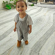 Varsashua participe au concours pour gagner de l'argent avec cette photo : toddler, child, smiling, overalls, boots, marble_floor, outdoor, gate, greenery, happy, person, young_child, casual_clothing, short_hair, standing, daylight, playful, cute, portrait, small_person