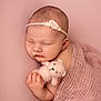 Hallie joined the competition — help win amazing prizes! newborn, baby, sleeping, pink, blanket, knitted_toy, teddy_bear, headband, flower, soft_texture, cute, peaceful, closeup, infant, portrait, wrapped, hand, skin, resting, studio_photo