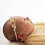 Hallie is registered to the contest to win money with this photo: newborn, baby, sleeping, headband, flower, pillow, blanket, knit, soft, peaceful, infant, resting, side_profile, cute, toddler, child, portrait, indoors, closeup, calm