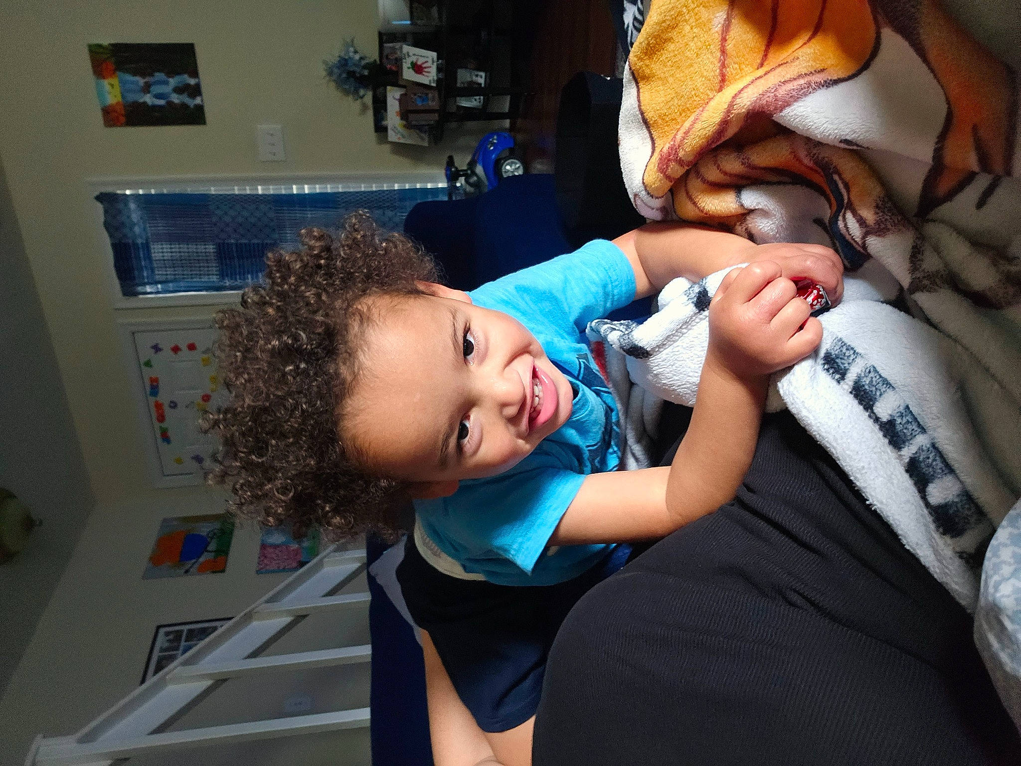 Julien is registered to the contest to win money with this photo: baby, child, comfort, elbow, electric_blue, flash_photography, fun, happy, hat, leisure, person, room, shelf, sitting, thigh, toddler