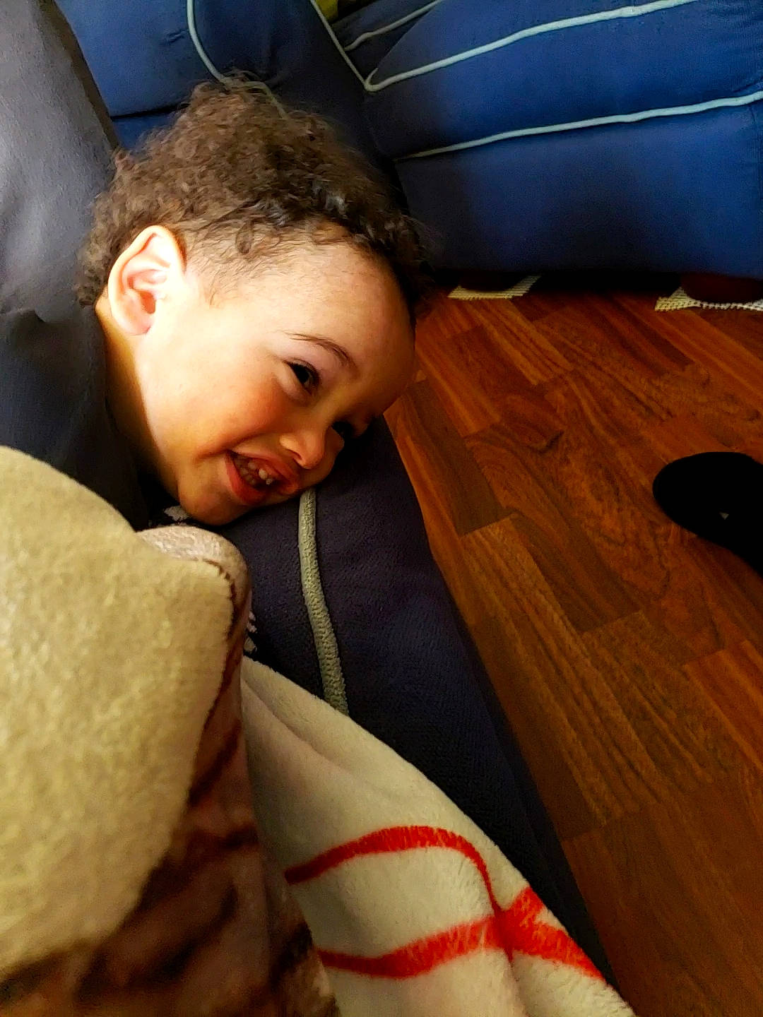 Julien joined the competition — help win amazing prizes! carmine, child, comfort, elbow, finger, flooring, fur, happy, hardwood, human_leg, linens, nap, nose, person, room, sitting, skin, toddler, varnish, wood