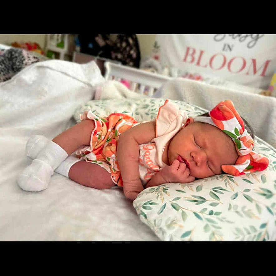 Kaliya joined the competition — help win amazing prizes! baby, blanket, child, clothing, cozy, crib, cute, floral, headband, indoors, infant, newborn, nursery, peaceful, person, pillow, portrait, resting, sleeping, soft