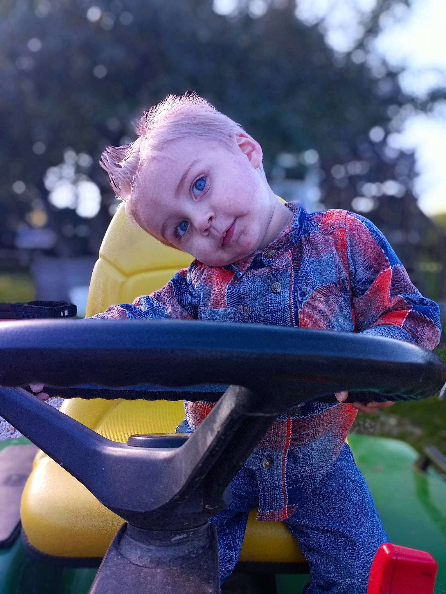 Greysen is registered to the contest to win money with this photo: baby_carriage, baby_products, child, city, electric_blue, fun, grass, happy, leisure, outdoor_play_equipment, people_in_nature, person, play, playground, playground_slide, recreation, red, sitting, toddler, tree