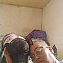 Xena is registered to the contest to win money with this photo: person, dog, glasses, indoor, wall, ceiling, jacket, pet, face, head, closeup, expression, companion, animal, human, affection, bond, casual, wearing, friendship