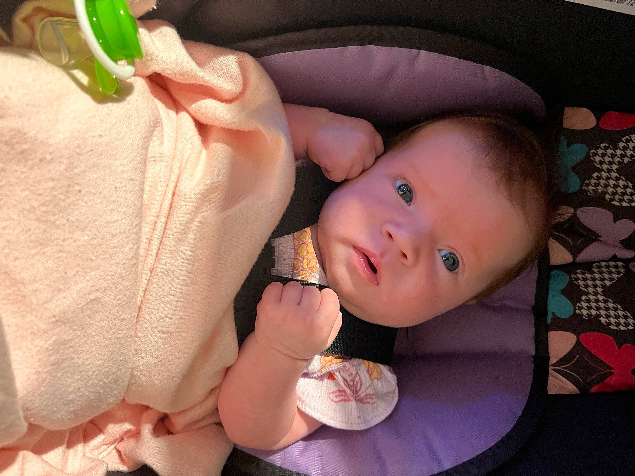Izabella is registered to the contest to win money with this photo: arm, baby, baby_toddler_clothing, cheek, comfort, facial_expression, finger, food, gesture, green, hand, head, human_body, leg, mouth, nose, person, pink, skin, thumb