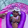 Milani joined the competition — help win amazing prizes! baby, child, pool, floatie, water, purple, hat, bow, teether, hand, adult, summer, outdoor, cute, infant, swimming, relaxing, swimwear, floating, playful