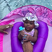 Milani is registered to the contest to win money with this photo: baby, child, pool, floatie, water, purple, hat, bow, teether, hand, adult, summer, outdoor, cute, infant, swimming, relaxing, swimwear, floating, playful