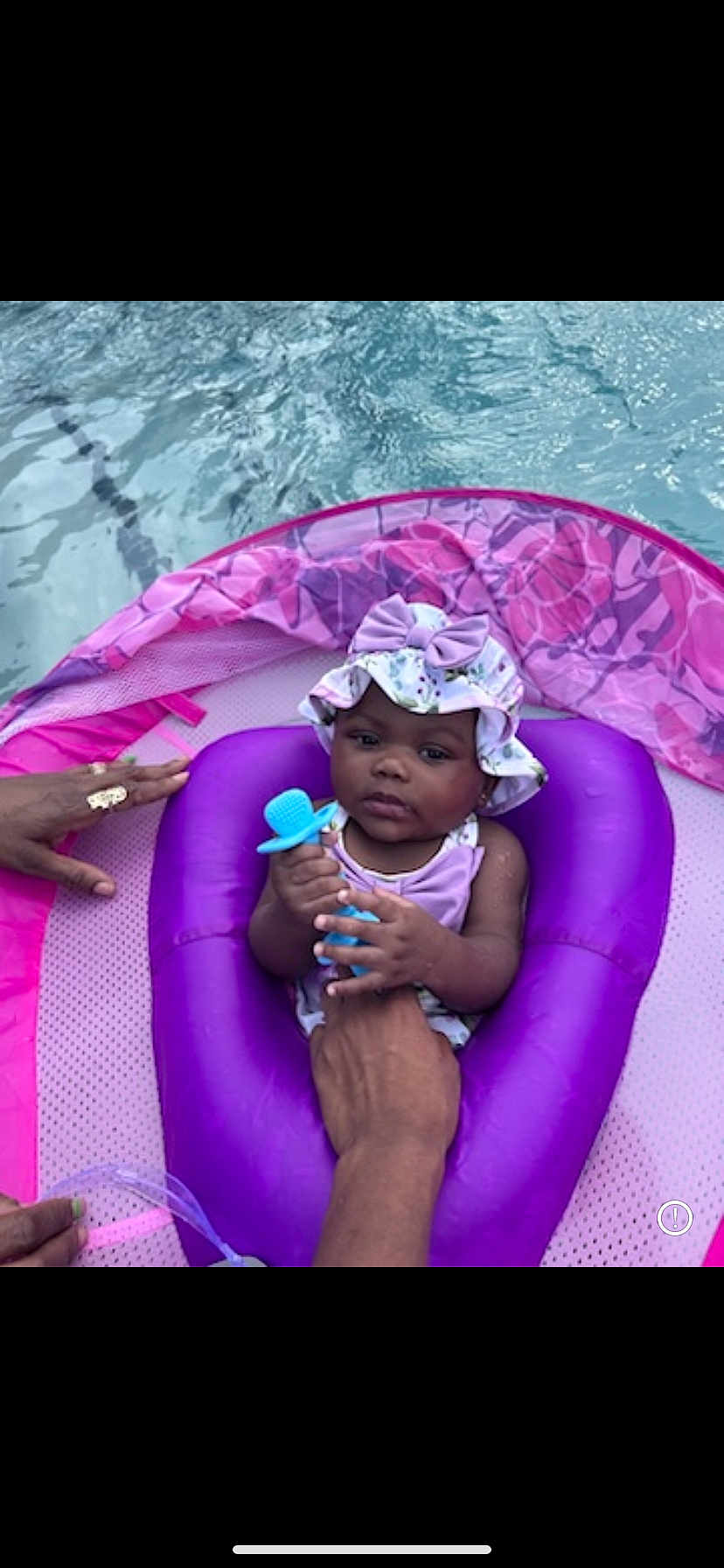 Milani is registered to the contest to win money with this photo: baby, child, pool, floatie, water, purple, hat, bow, teether, hand, adult, summer, outdoor, cute, infant, swimming, relaxing, swimwear, floating, playful