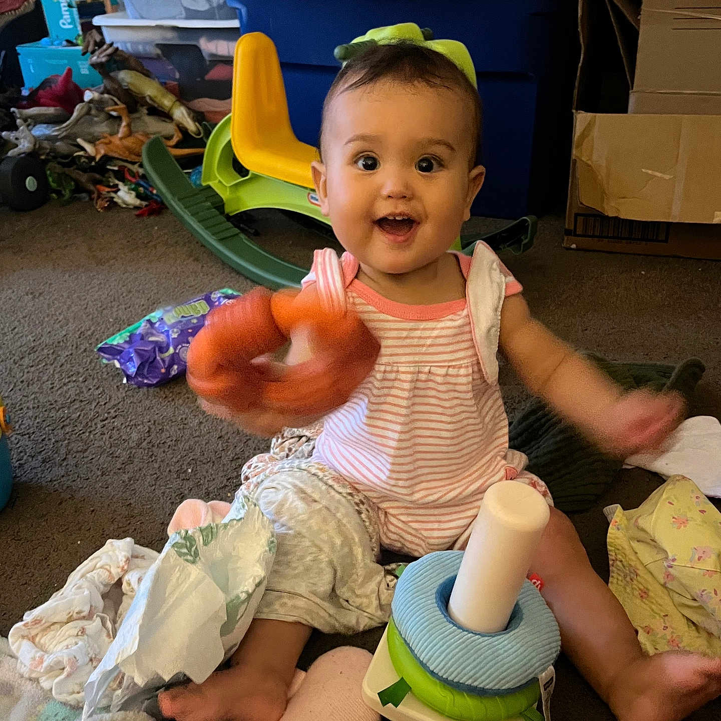 Kamryn joined the competition — help win amazing prizes! baby, child, toy, carpet, smiling, indoor, clothing, diaper, play, colorful, plastic_toy, sitting, blanket, box, storage_bin, happy, face, hand, foot, home